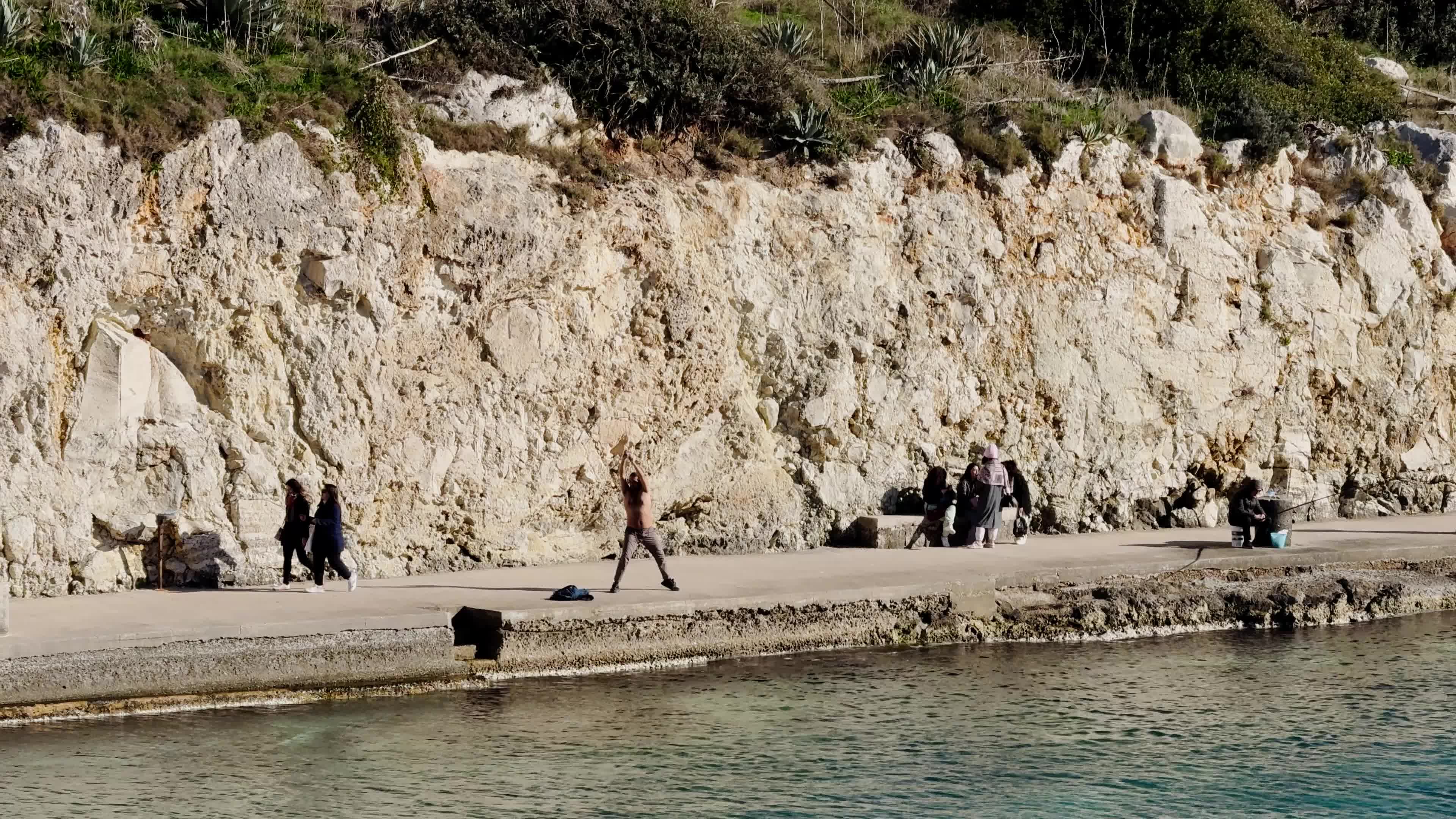 Swimmers Enjoy the Sea in Tricase Porto Amid Mild Winter Weather